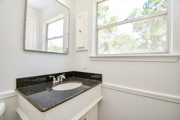 a bathroom with a sink and a window