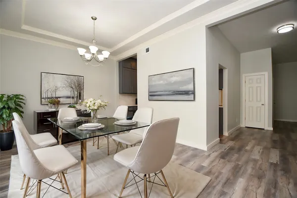 a view of a dining room with furniture wooden floor and chandelier