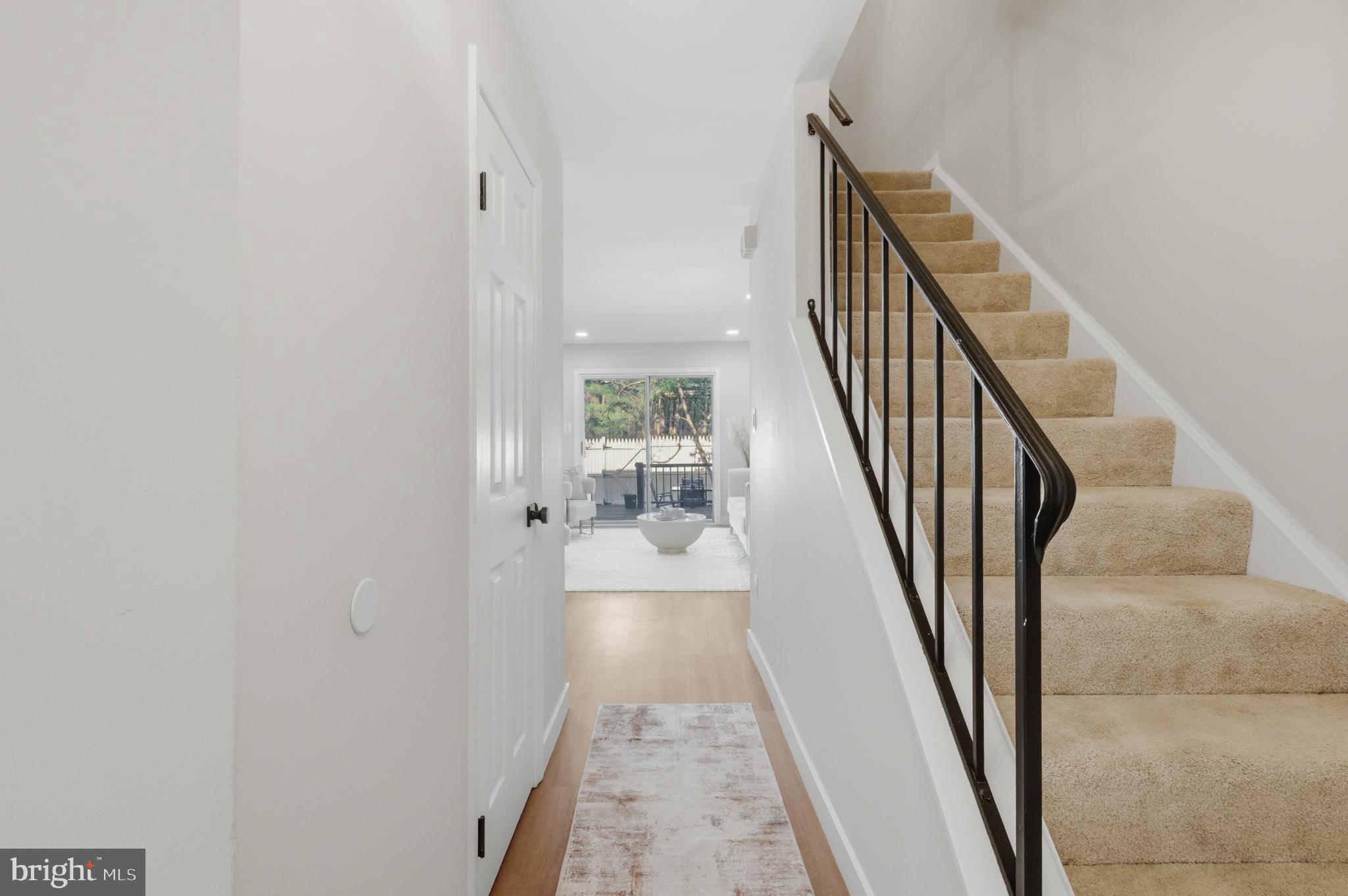 8575 Tyrolean Way Springfield, VA 22153 - Photo 2 of 29 a view of a hallway with wooden floor and staircase