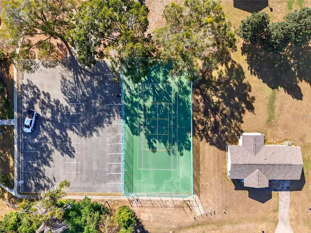 a view of a yard in front of a house with large trees