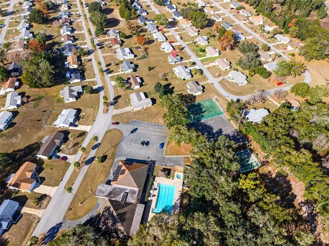 an aerial view of a house with a yard