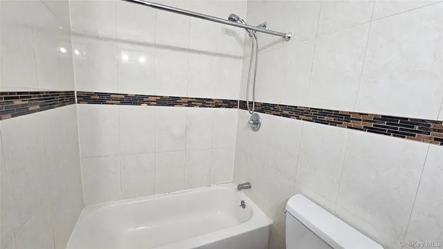 a bathroom with a shower and a bath tub