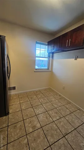 a view of a livingroom with an empty space and a window