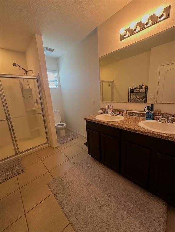 3640 Seneca Club Loop, Unit 46103 Orlando, FL 32808 - Photo 7 of 7 a bathroom with a sink a toilet and mirror
