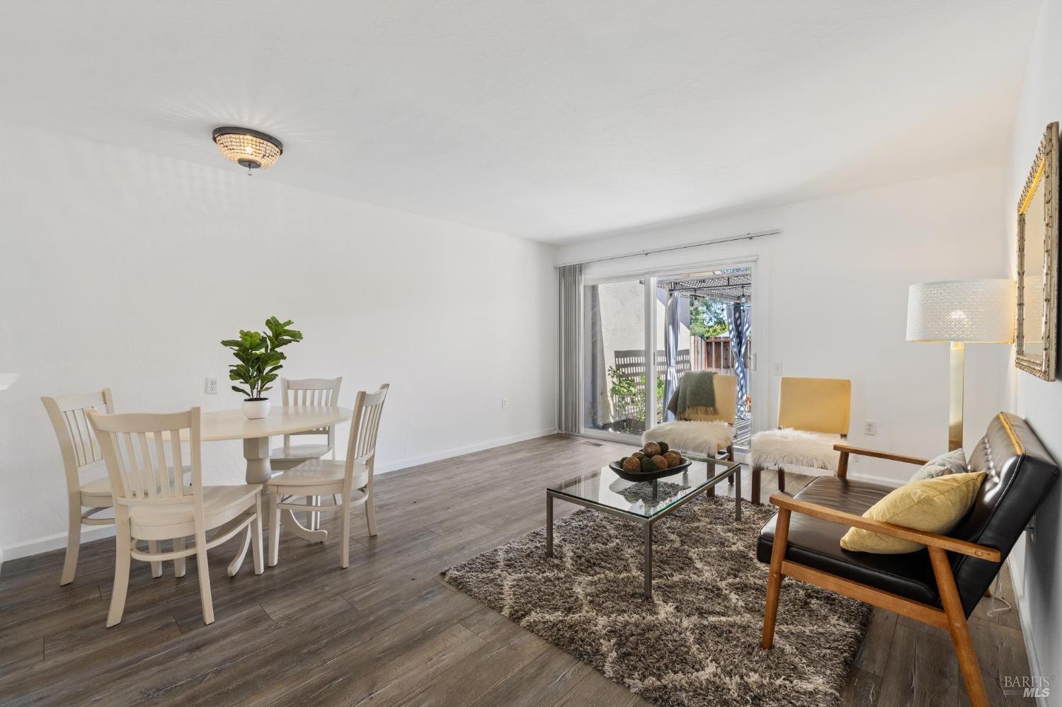 21 Vineyard Circle Sonoma, CA 95476 - Photo 3 of 23 a living room with furniture a wooden floor and a potted plant