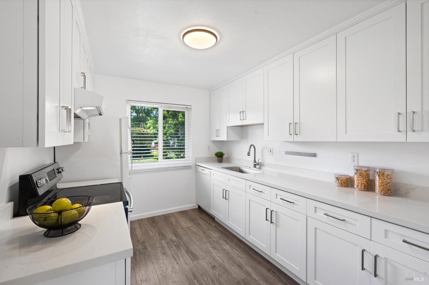 21 Vineyard Circle Sonoma, CA 95476 - Photo 6 of 23 a kitchen with a sink and white cabinets
