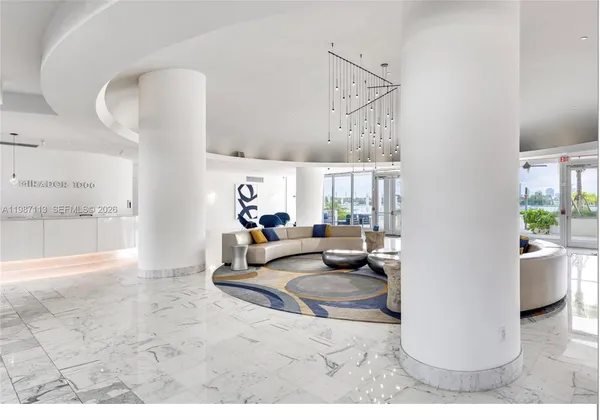 a living room with furniture and a painting on the wall