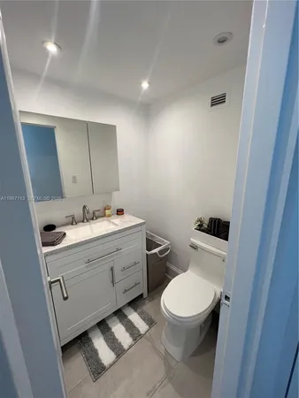 a bathroom with a toilet a sink and mirror