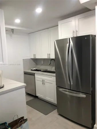 a kitchen with stainless steel appliances a refrigerator sink and microwave