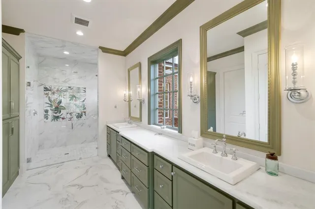 a spacious bathroom with a double vanity sink mirror and shower