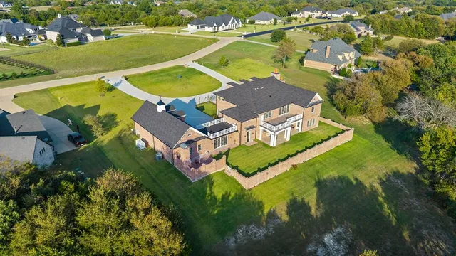 an aerial view of residential houses with outdoor space and swimming pool