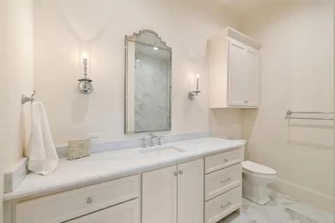 a bathroom with a sink a toilet and a mirror