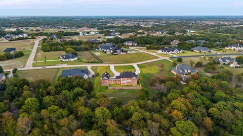 an aerial view of a residential houses with a swimming pool