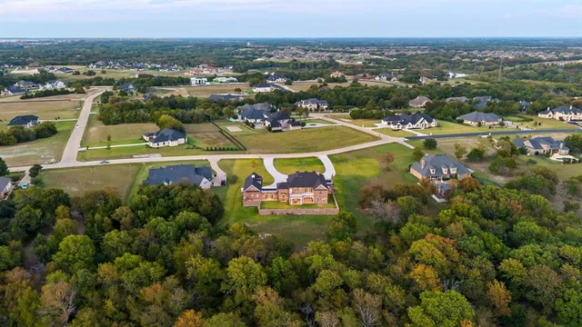 an aerial view of a residential houses with a swimming pool