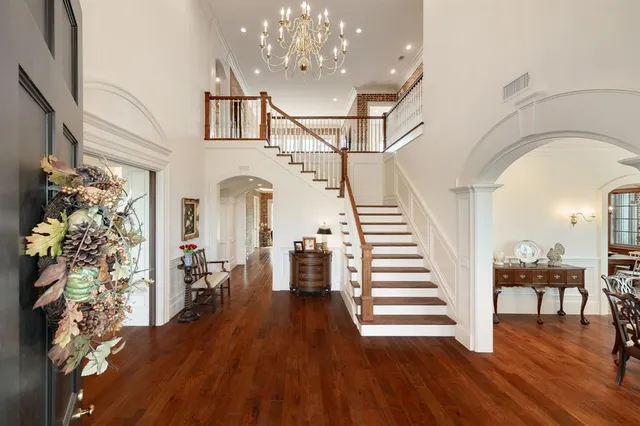 a view of entryway and hall with wooden floor