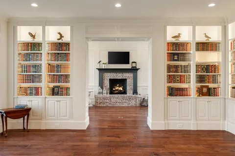 a living room with a fireplace cabinet and a flat screen tv