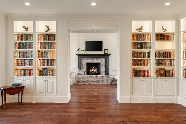 a living room with a fireplace cabinet and a flat screen tv