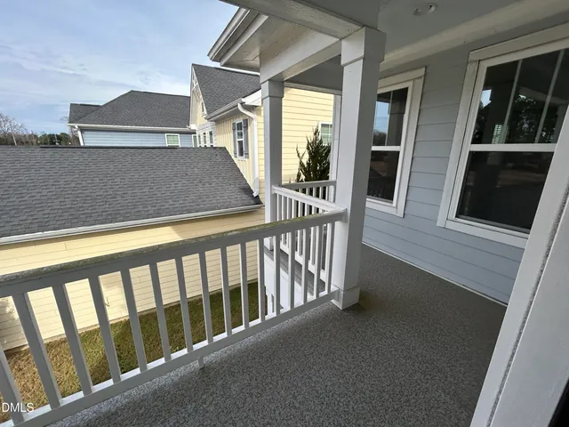 a view of balcony with wooden floor