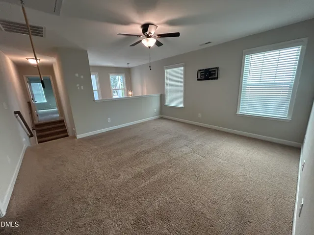 a view of an empty room and a window