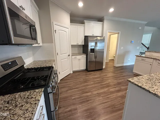 a kitchen with a refrigerator a stove top oven a sink and dishwasher