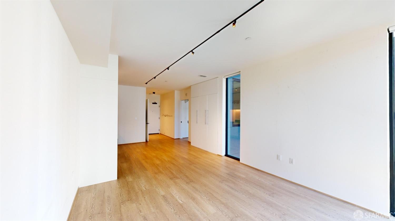 241 10th Street, Unit 305 San Francisco, CA 94103 - Photo 3 of 16 a view of a big room with wooden floor