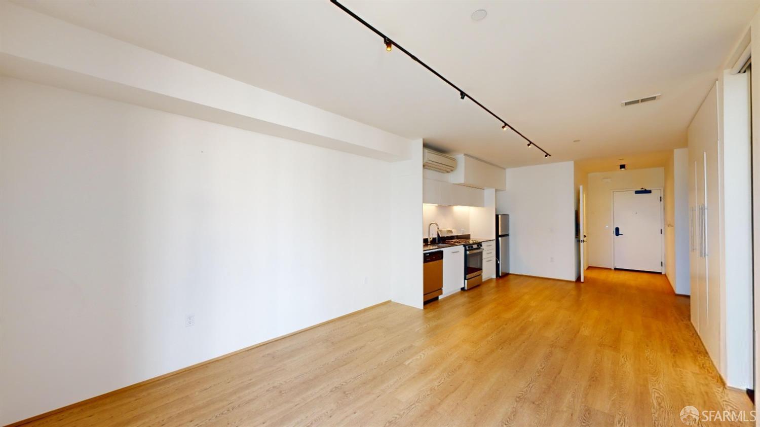 241 10th Street, Unit 305 San Francisco, CA 94103 - Photo 7 of 16 a view of a kitchen with wooden floor