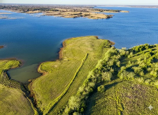 a blue swimming pool is sitting in a lake