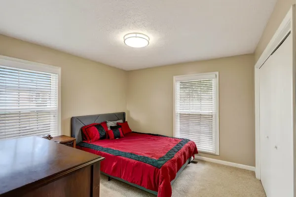 a bedroom with a bed and a table