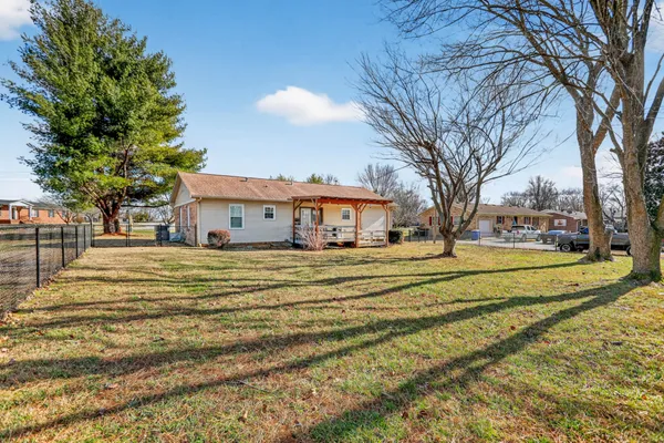 a view of a swimming pool with a house in the background