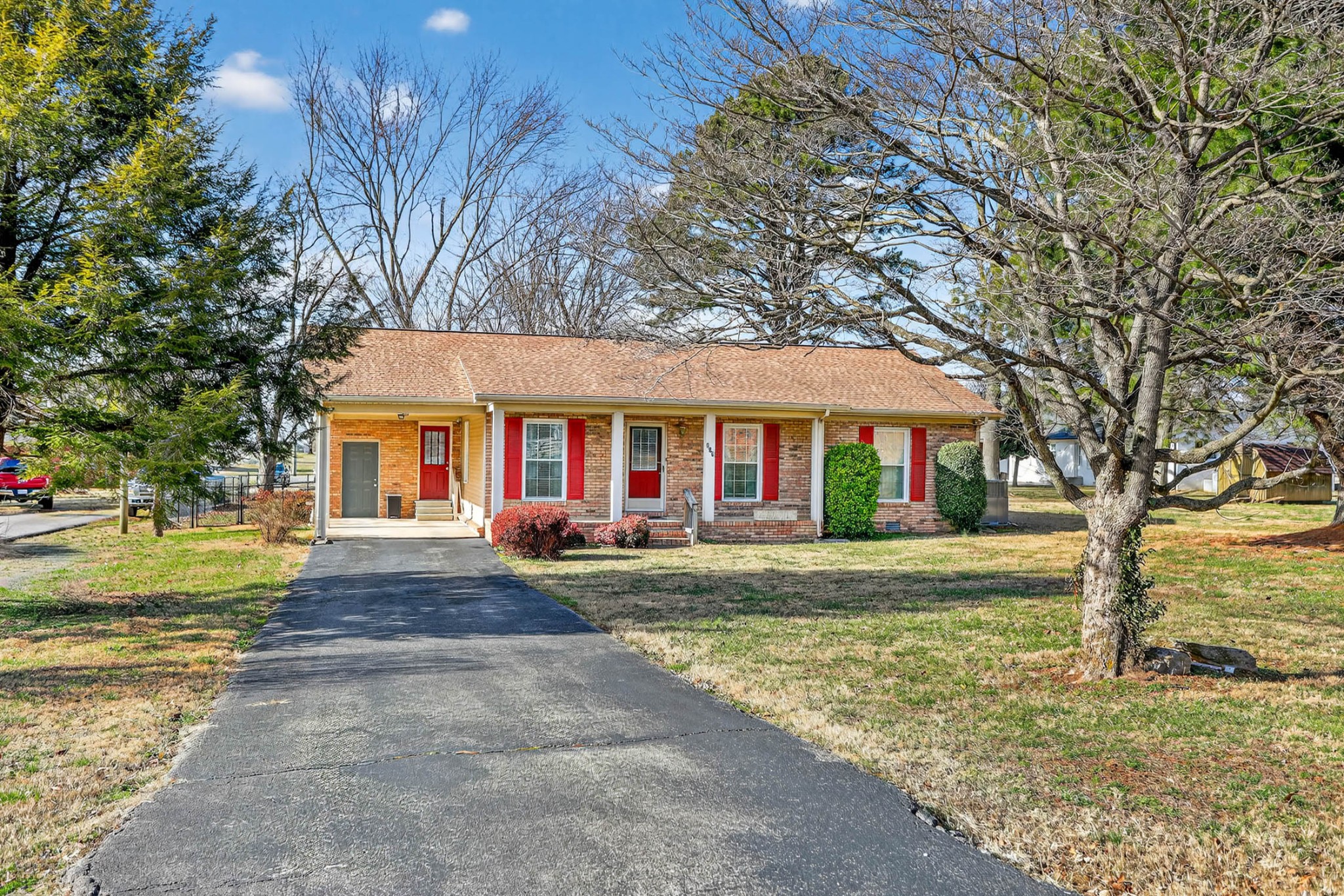 257 North Fairway Road Franklin, KY 42134 - Photo 25 of 30 a view of a brick house with a big yard and large trees