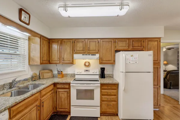 a white refrigerator freezer sitting in a kitchen