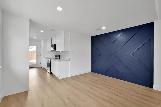 a view of kitchen with wooden floor and electronic appliances