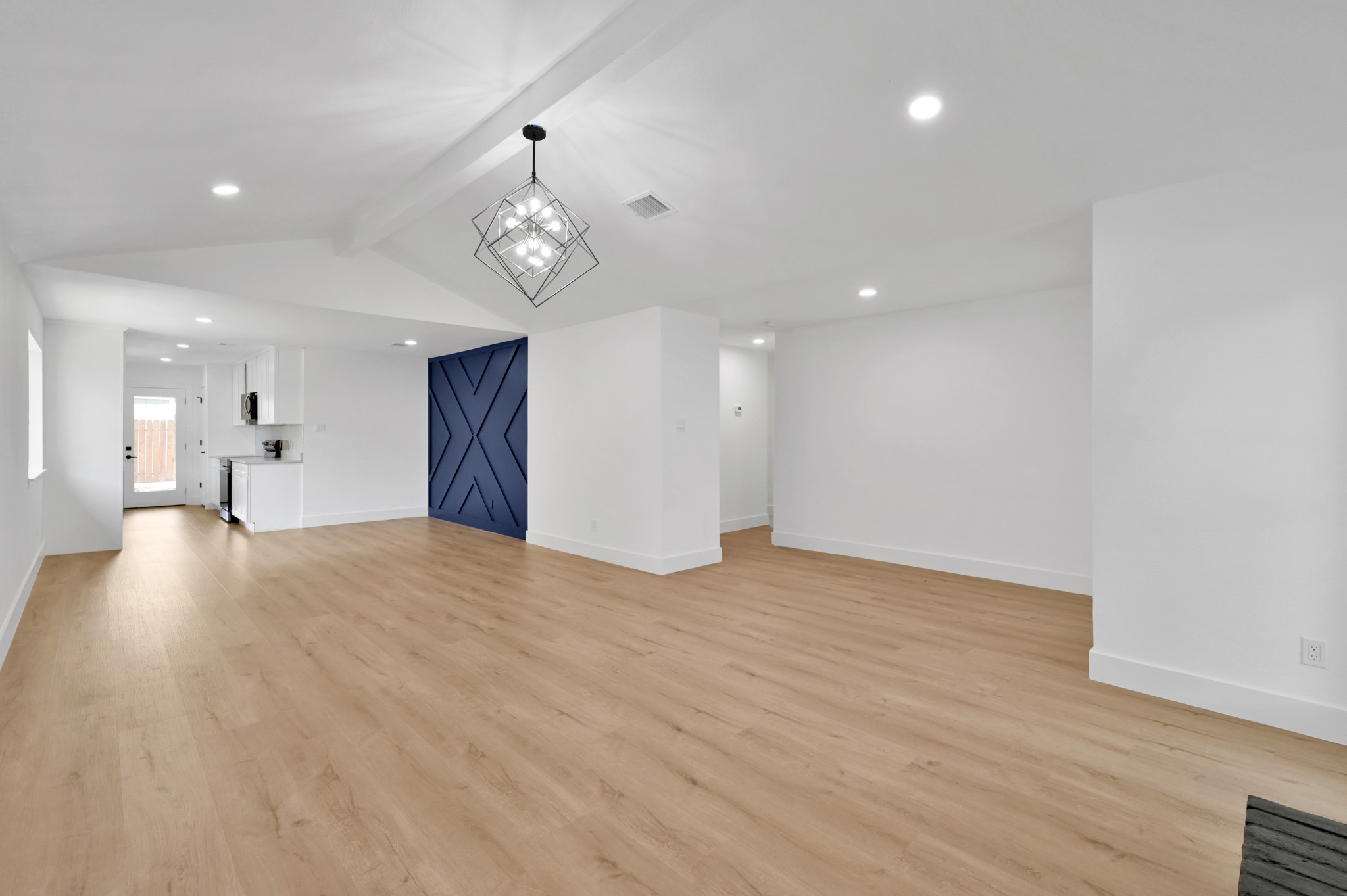 5015 Monteith Drive Spring, TX 77373 - Photo 19 of 44 a view of empty room with wooden floor and kitchen view