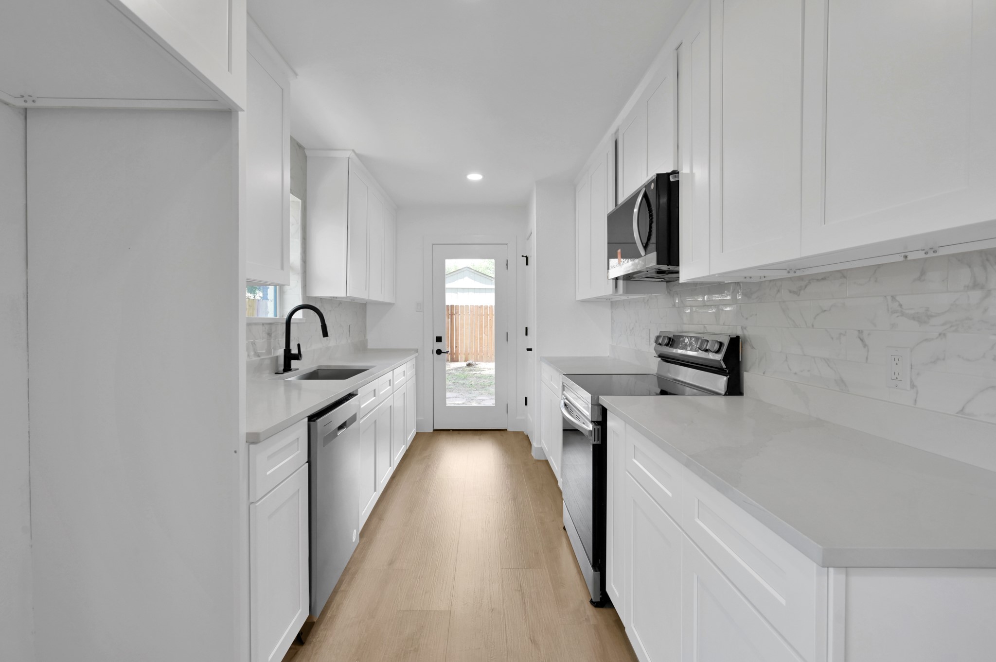 5015 Monteith Drive Spring, TX 77373 - Photo 21 of 44 a kitchen with stainless steel appliances a sink stove top oven and cabinets