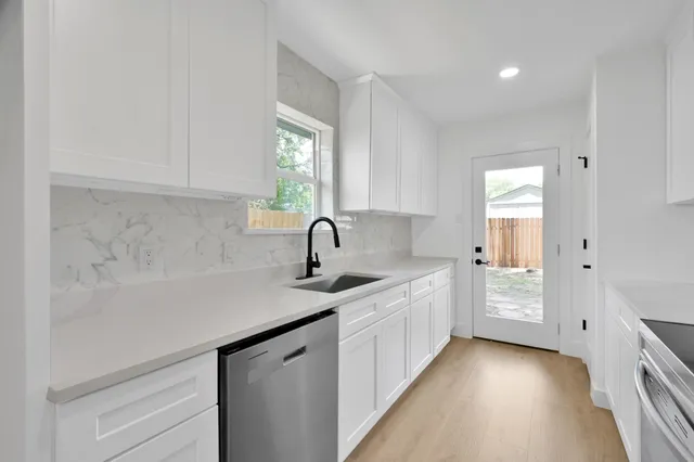 a kitchen with a sink and cabinets