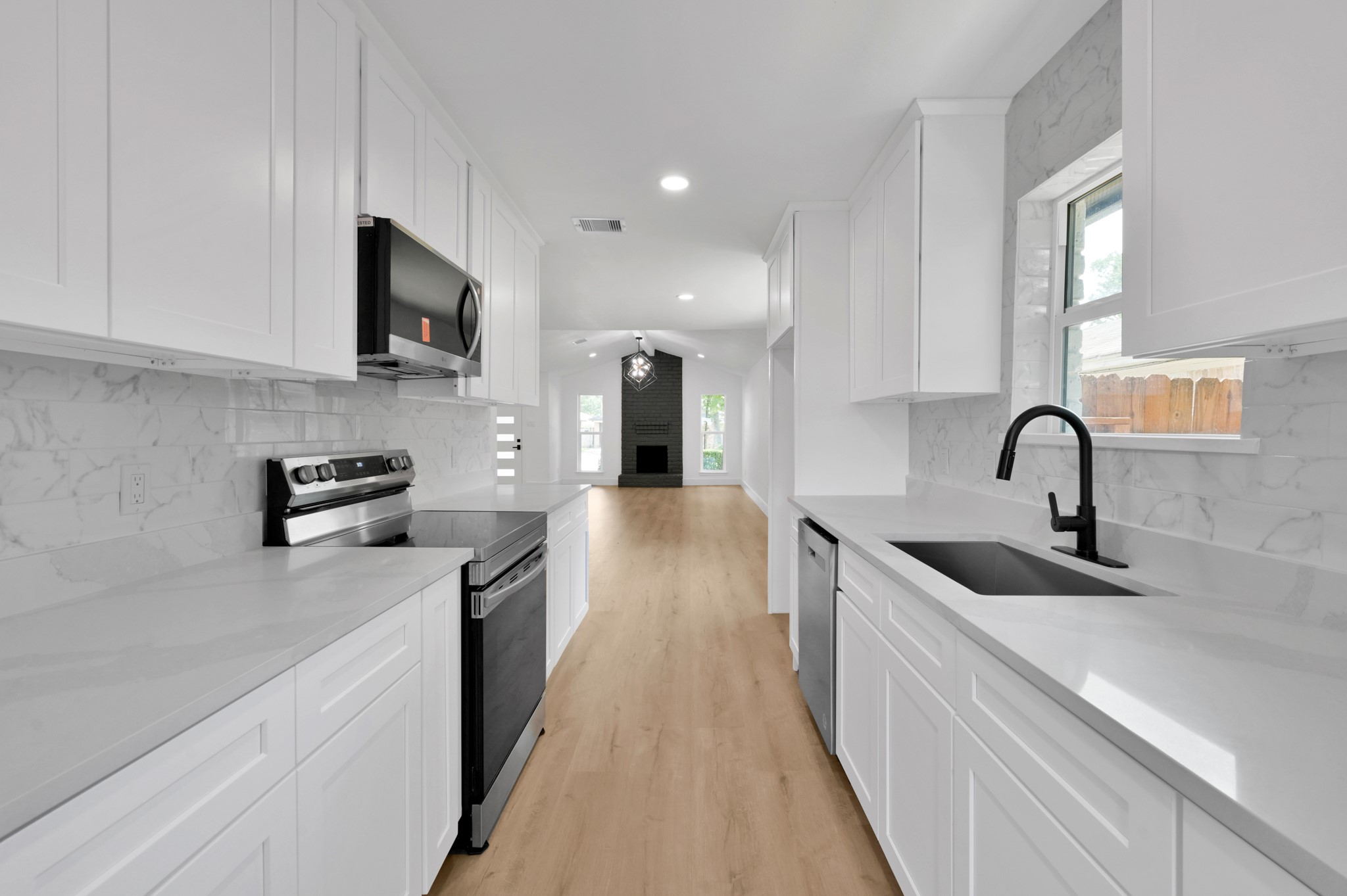 5015 Monteith Drive Spring, TX 77373 - Photo 23 of 44 a kitchen with stainless steel appliances granite countertop a sink stove and refrigerator