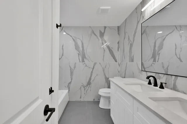 a bathroom with a sink a toilet and a shower