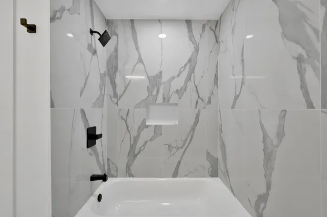 a bathroom with a shower and a tub