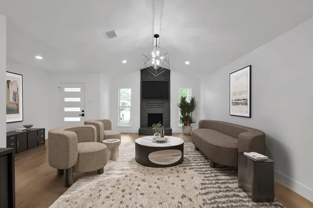 a living room with furniture and a fireplace