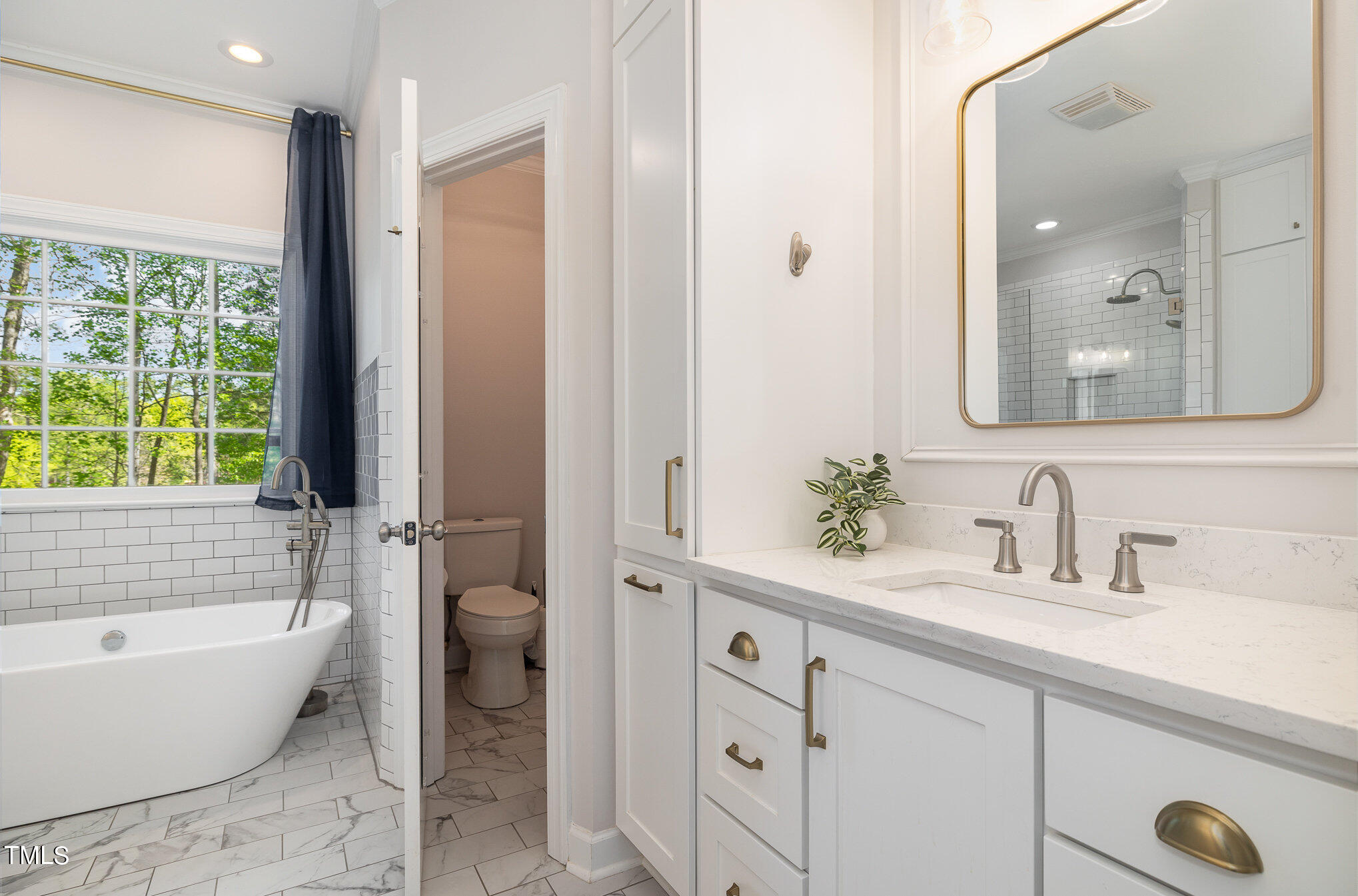 3705 La Costa Way Raleigh, NC 27610 - Photo 16 of 40 a bathroom with a tub a sink and a large mirror