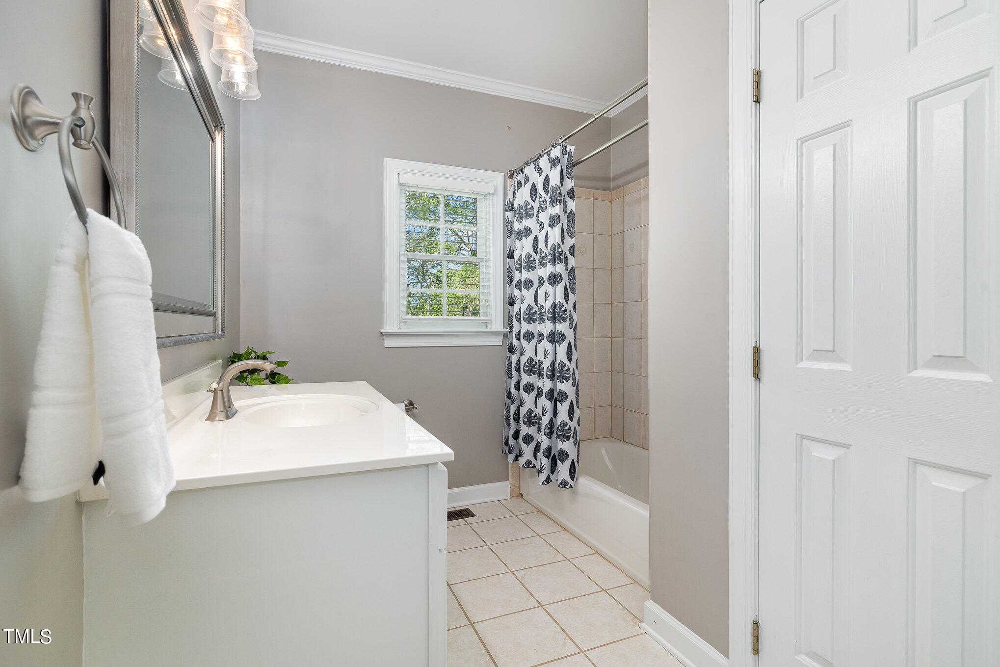 3705 La Costa Way Raleigh, NC 27610 - Photo 19 of 40 a bathroom with a bathtub a sink and a window