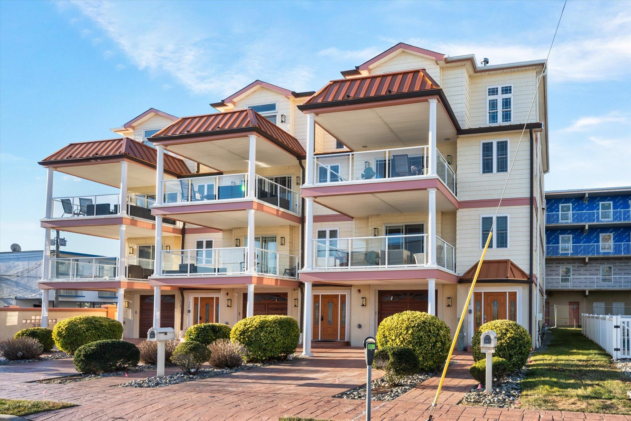a front view of a building and car parked