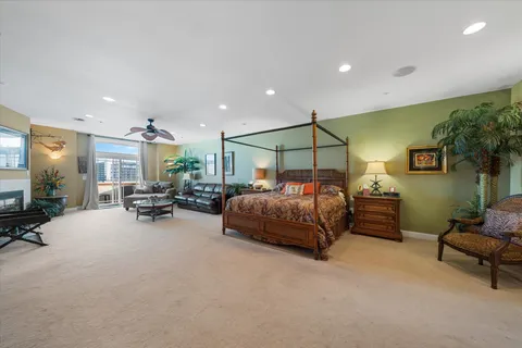 a living room with fireplace furniture and a large window