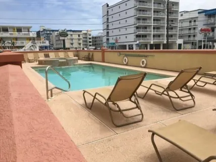 a swimming pool with outdoor seating and city view