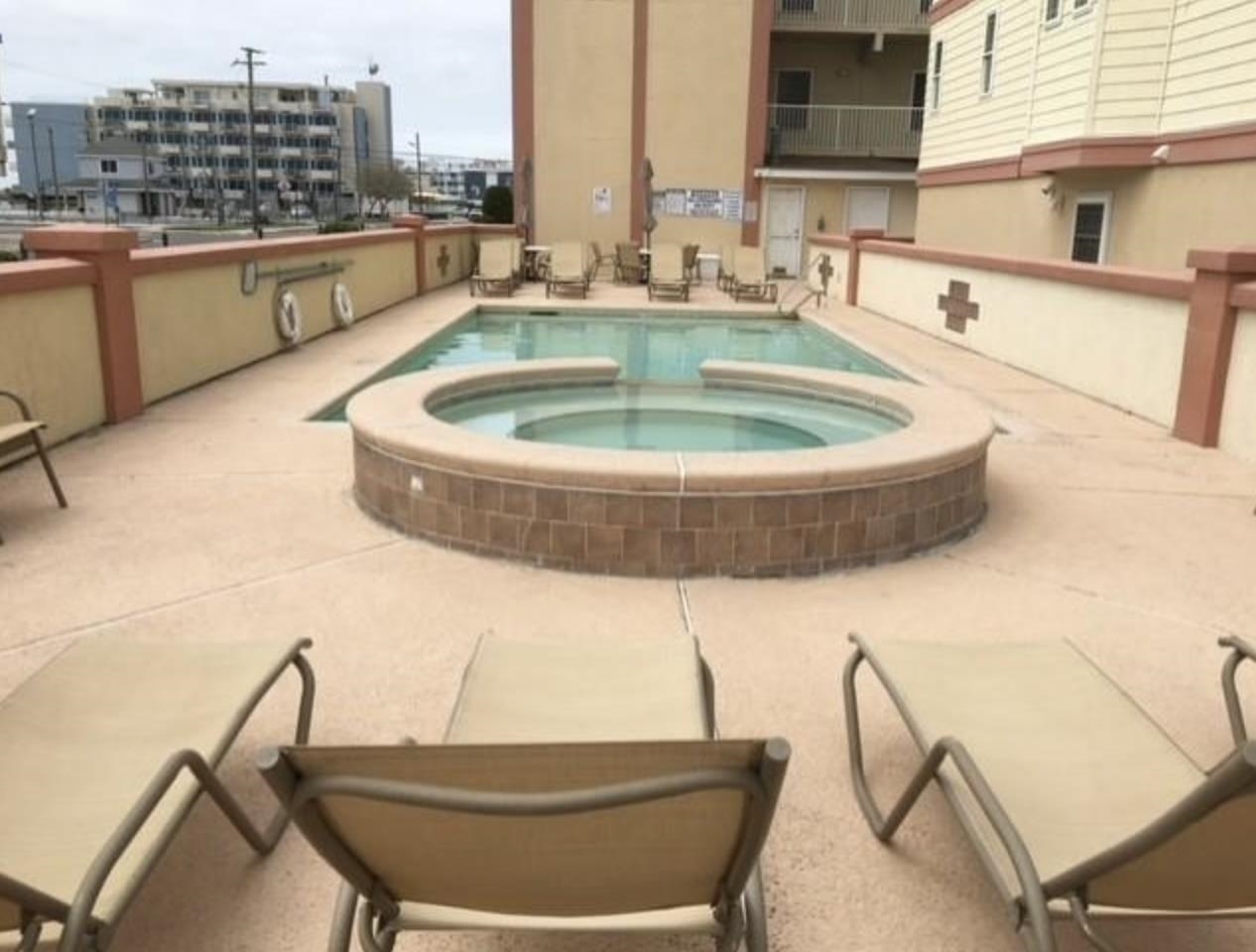420 East Lavender Road, Unit 420 Wildwood Crest, NJ 08260 - Photo 36 of 41 a swimming pool with outdoor seating and city view