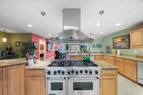 a kitchen with stainless steel appliances granite countertop a stove and a sink