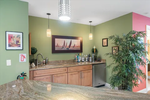 a kitchen with sink and view of living room