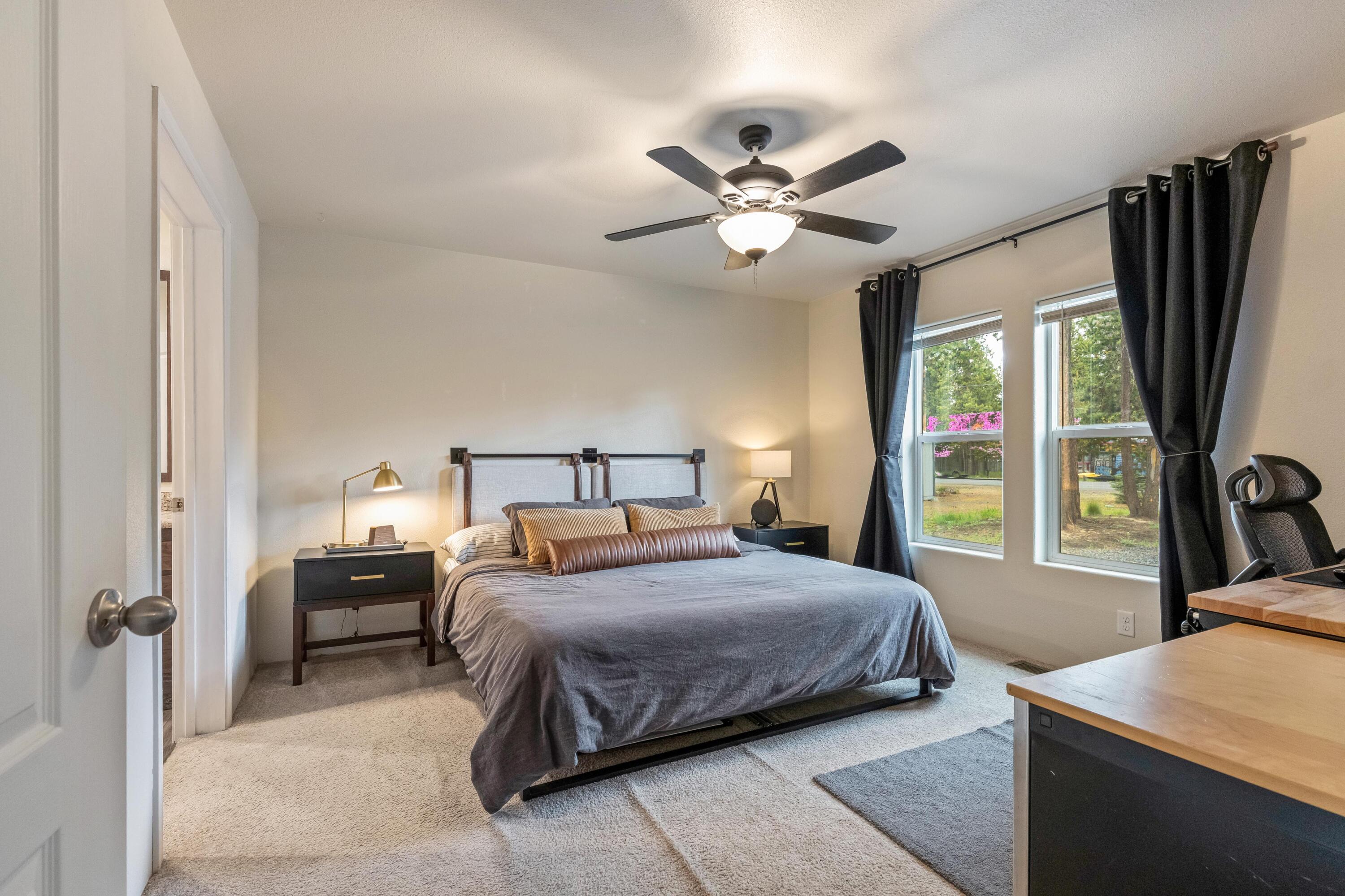 55823 Snow Goose Road Bend, OR 97707 - Photo 13 of 36 a bedroom with a large bed and a large window
