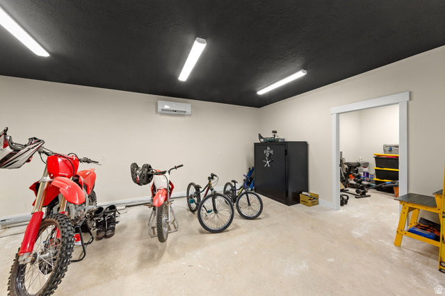 2591 East Washington Dam Road Washington, UT 84780 - Photo 58 of 67 Spacious utility room featuring a black ceiling, light beige walls, and light-colored concrete flooring