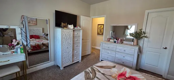 a bedroom with a bed and a television